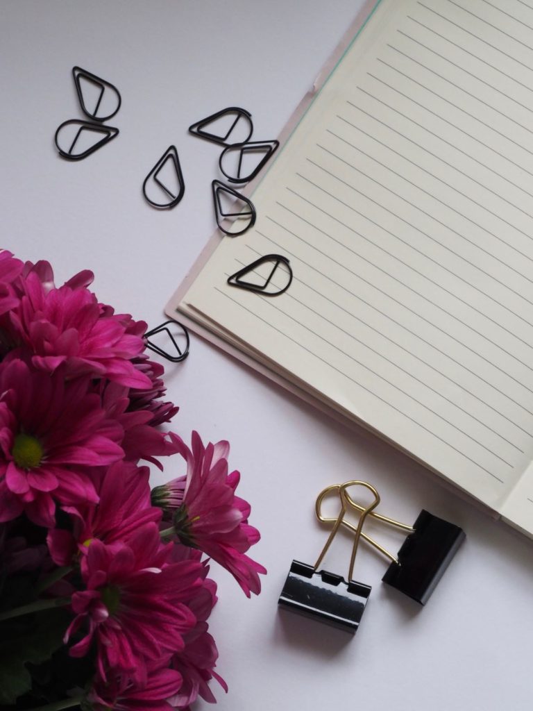 paper clips on writing notebook